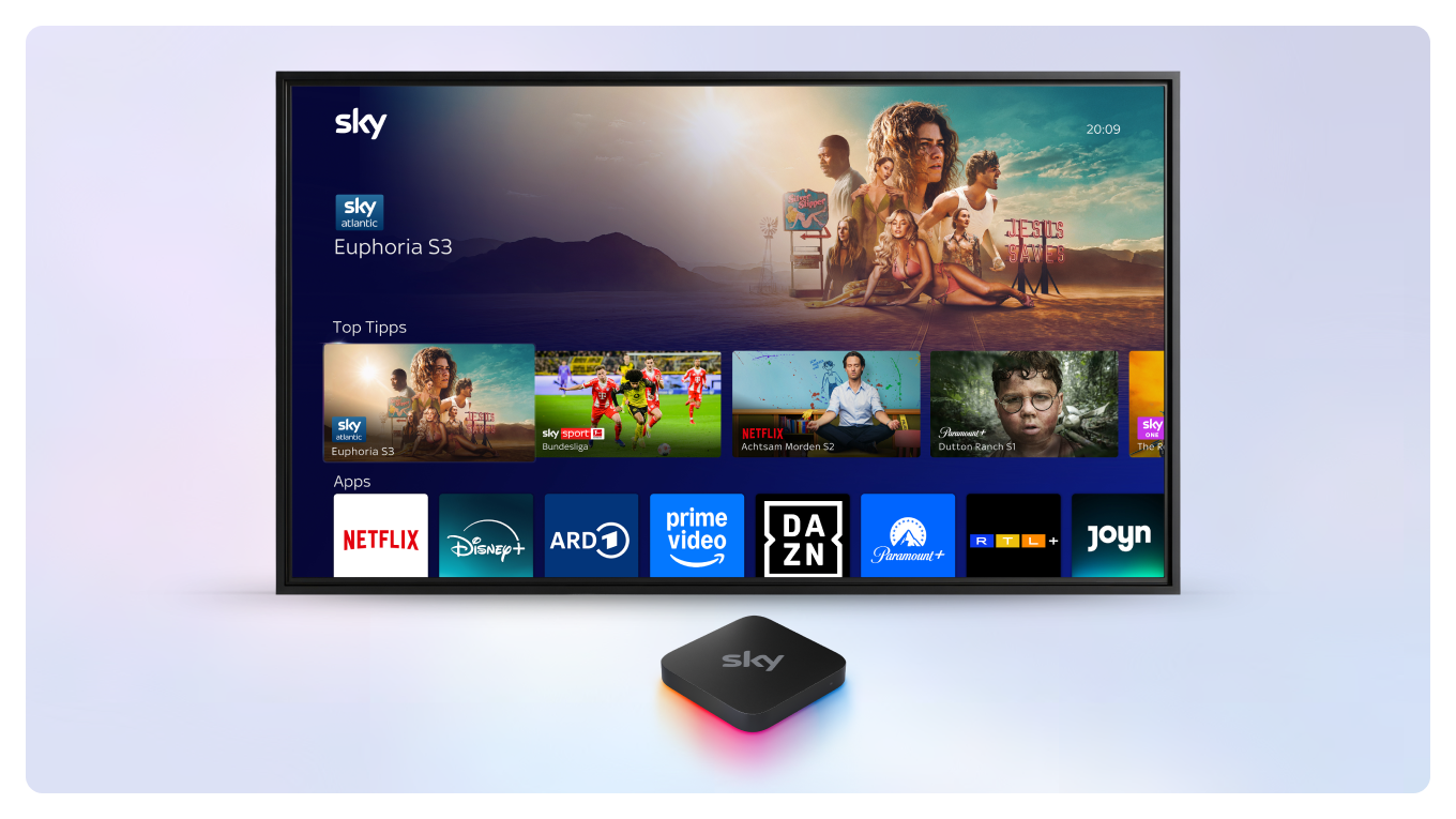 Sky Stream Box vor einem Fernseher, auf dem das Sky Stream UI zu sehen ist.